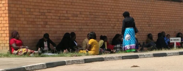 Some ZNBC employees sitting outside the Mass Media studio
