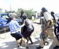 Police officers arrest people found looting in Lusaka's Chaisa Township-picture by Tenson Mkhala
