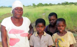 The three children adopted by Stella Sata-Rukayi with their grandmother