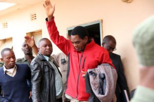 UPND leader Hakainde Hichilema waves at his supporters at Lusaka's Magistrates Court before being taken to Lusaka Central Prisons-pictures by Tenson Mkhala