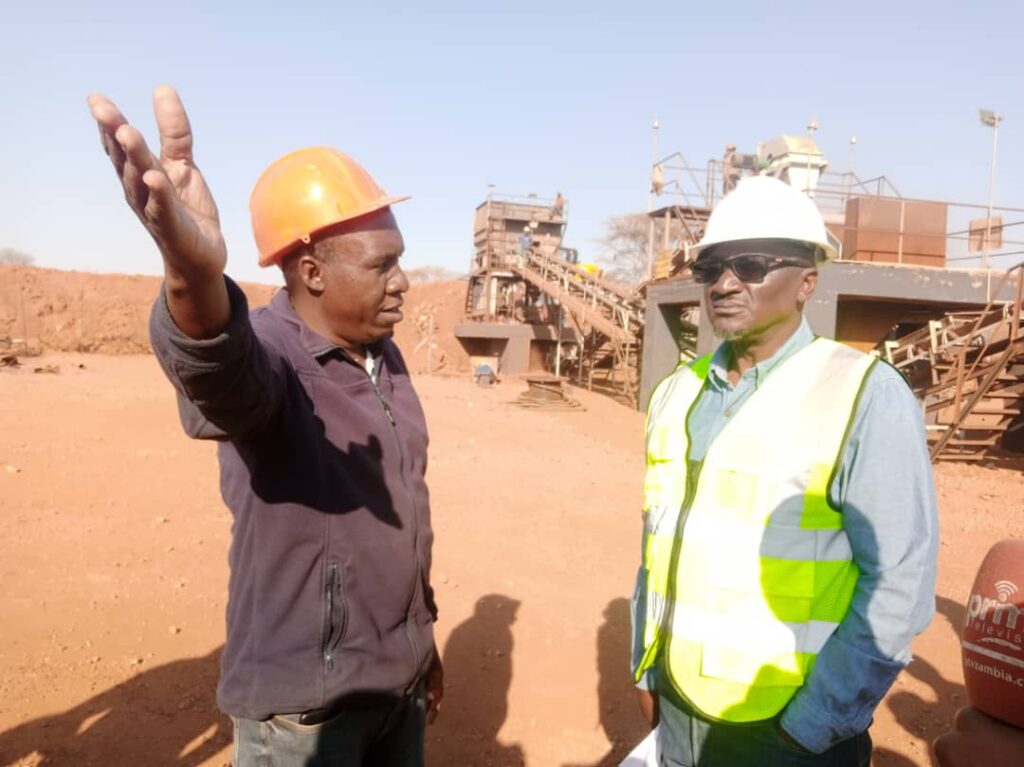 Minister of Green Economy and Environment Collins Nzovu listening to OreZone Mining Limited Manager Vusa Moyo when he toured the mine – Picture by Philip Chisalu