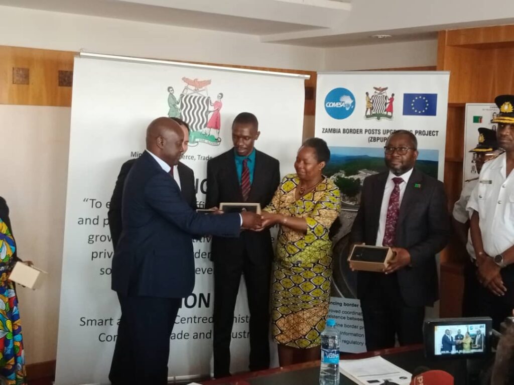 Ministry of Commerce, Trade and Industry Permanent Secretary Lillian Bwalya hands over equipment procured under the COMESA Trade Facilitation Programme: Zambia Border Post Upgrade Project to RTSA and the Department of Immigration