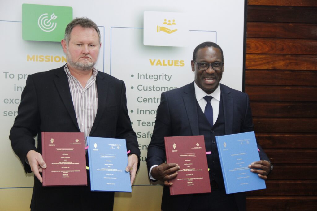 ZESCO Managing Director Victor Mapani (r) with First Quantum Chief Operating Officer Rudi Badenhorst (l) displaying the signed documents during a power supply agreement signing ceremony at ZESCO Head Quarters in Lusaka yesterday -Picture by Chongo Sampa